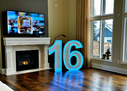 Glowing blue marquee numbers 16 in a living room with fireplace
