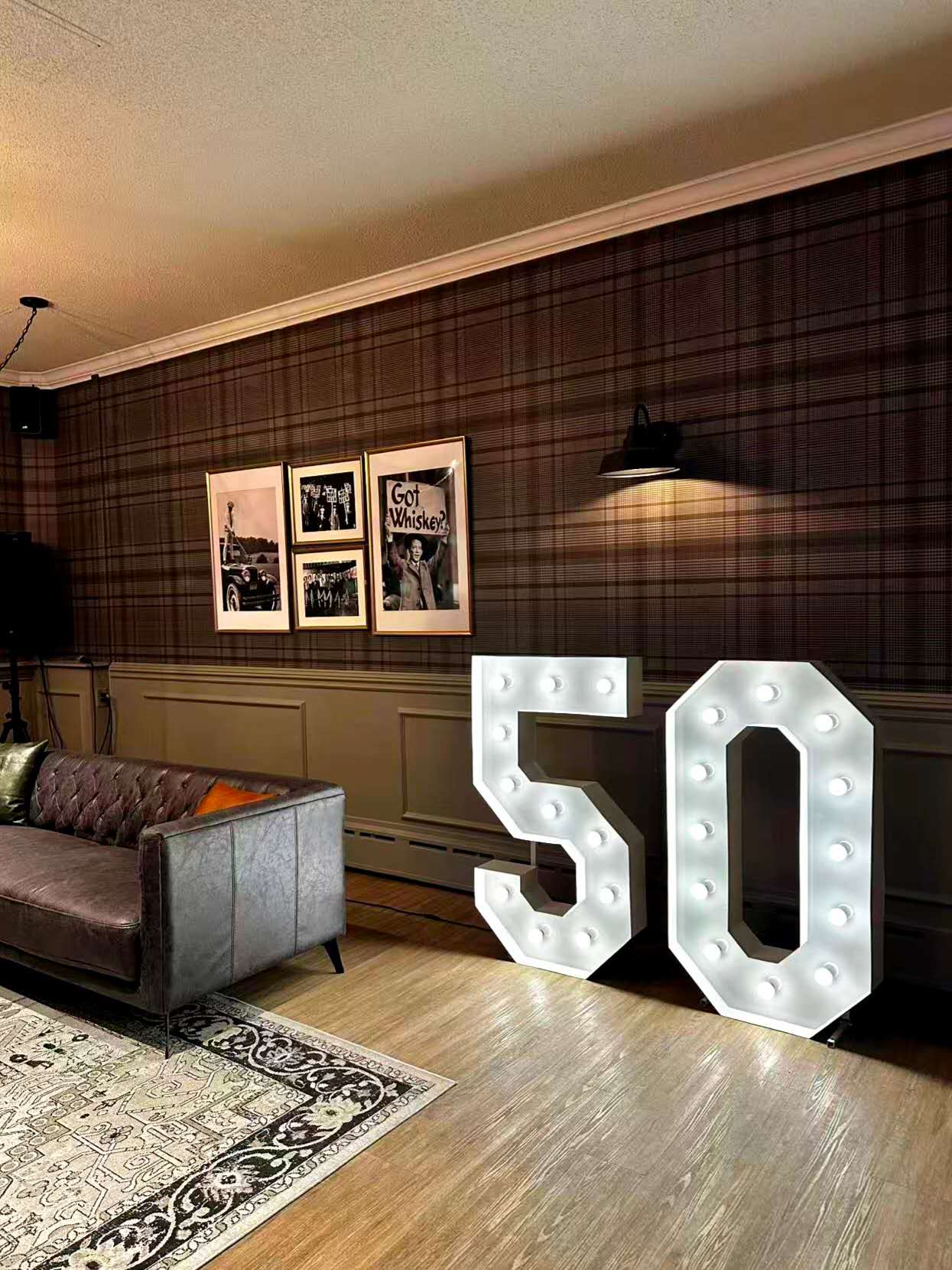 Large illuminated marquee numbers 50 in an elegant lounge